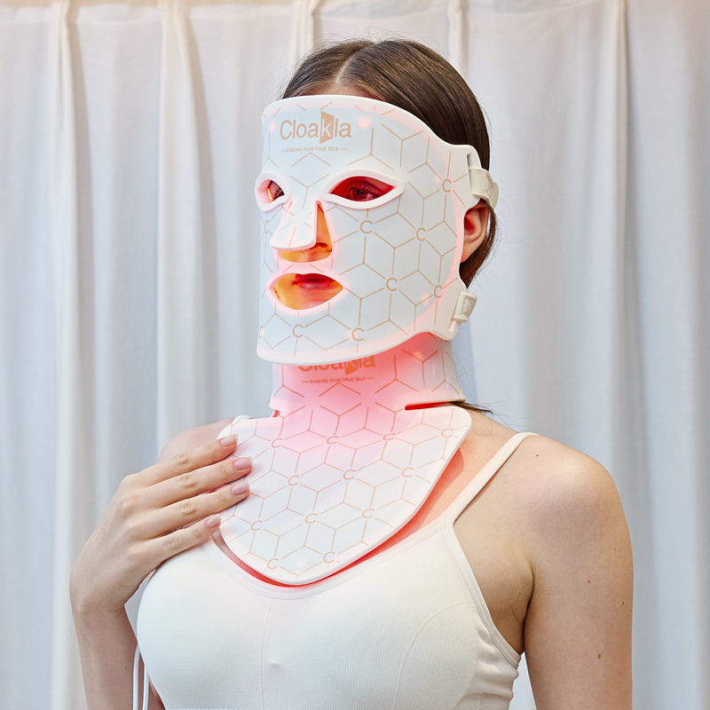 Cloakla K11 red light therapy face mask and neck panel worn by woman showing red LED light treatment